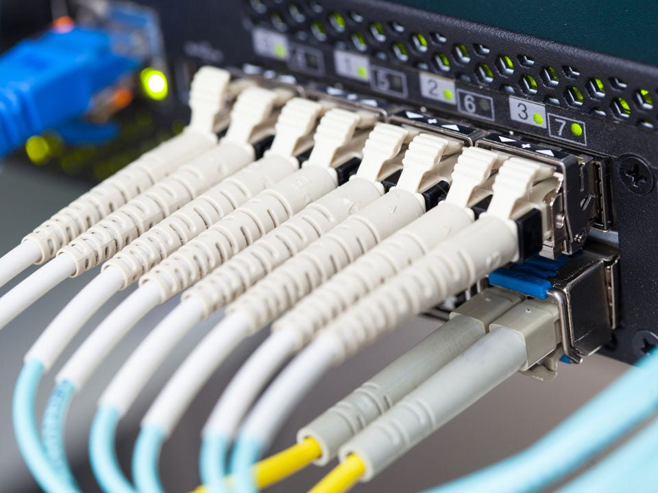 Ethernet cables plugging into a server rack