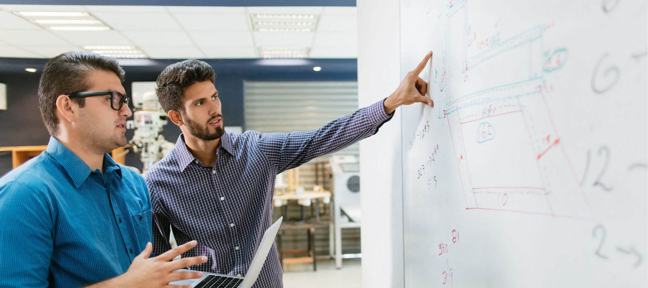 Two engineers thinking about a strategy, a solution.